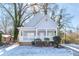 Charming light gray house with a front porch and snow-covered yard at 1156 Tucker Sw Pl, Atlanta, GA 30310