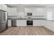 Modern kitchen with white cabinets and stainless steel appliances at 1156 Tucker Sw Pl, Atlanta, GA 30310