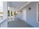 Long front porch with white railing and gray flooring at 1156 Tucker Sw Pl, Atlanta, GA 30310