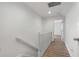 Upstairs hallway with wood-look flooring and access to bedrooms at 1156 Tucker Sw Pl, Atlanta, GA 30310