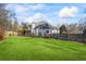 Large backyard with grassy lawn and wooden fence at 1160 Lea Dr, Roswell, GA 30076