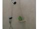 Close-up of a shower setup with dual shower heads and tiled walls with built-in shelf at 2804 Cumberland Ct, Smyrna, GA 30080