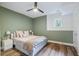 Basement bedroom with light green walls, hardwood floors, and a queen-size bed at 510 Watergate Ct, Roswell, GA 30076