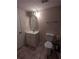 Simple bathroom with white vanity, tile floor, and a decorative mirror at 21 Muncy Se Ct, Smyrna, GA 30080