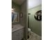 Clean bathroom with green walls, white vanity, and tile floor at 21 Muncy Se Ct, Smyrna, GA 30080