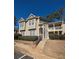 Two-story condo building with light beige siding, balconies, and landscaping at 21 Muncy Se Ct, Smyrna, GA 30080