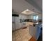 Galley kitchen with white cabinets, tile floors, and skylight at 21 Muncy Se Ct, Smyrna, GA 30080