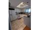Galley kitchen with white cabinets, tile floors, and skylight at 21 Muncy Se Ct, Smyrna, GA 30080