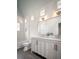 Charming bathroom with double vanity, white subway tile, and grey wood-look floors at 731 Belt Se Loop, Atlanta, GA 30316