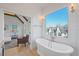 Luxurious bathroom with freestanding tub and view into bedroom at 731 Belt Se Loop, Atlanta, GA 30316