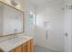 Modern bathroom with white subway tile, a large glass shower, and wood vanity at 731 Belt Se Loop, Atlanta, GA 30316