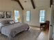Bright bedroom features a neutral color palette, wood beams, and three large windows offering abundant natural light at 731 Belt Se Loop, Atlanta, GA 30316