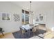 Sunlit dining room with concrete table, modern chandelier, and view to backyard at 731 Belt Se Loop, Atlanta, GA 30316