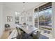 Modern farmhouse dining room with large windows and hardwood floors at 731 Belt Se Loop, Atlanta, GA 30316
