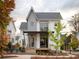 Charming two-story farmhouse with gray and white exterior, and a deck at 731 Belt Se Loop, Atlanta, GA 30316