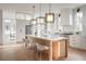 Modern kitchen with white cabinets and a large island with seating at 731 Belt Se Loop, Atlanta, GA 30316
