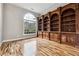 Home office with built-in bookcase and hardwood floors at 100 Dunwoody Creek Ct, Atlanta, GA 30350