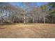 Open backyard with mature trees, offering privacy and space at 857 Garner Rd, Rockmart, GA 30153