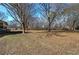 Spacious backyard with mature trees and a large grassy area at 857 Garner Rd, Rockmart, GA 30153