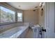 Bathroom with jetted tub, toilet and pedestal sink at 857 Garner Rd, Rockmart, GA 30153