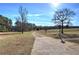 Long private driveway leading to a home with a large grassy yard and mature trees at 857 Garner Rd, Rockmart, GA 30153