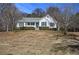 White house with gray roof and landscaping on a hill at 857 Garner Rd, Rockmart, GA 30153