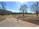 Long driveway leading to a charming house with mature trees at 857 Garner Rd, Rockmart, GA 30153