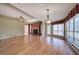 Open concept living area with hardwood floors, fireplace and sunroom access at 857 Garner Rd, Rockmart, GA 30153