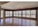 Sunroom with wall-to-wall windows offering scenic views and hardwood floors at 857 Garner Rd, Rockmart, GA 30153