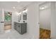 Modern bathroom with gray vanity, double sinks, and tiled floors at 1583 Columbia Cir, Decatur, GA 30032