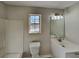 Simple bathroom with white vanity, toilet and window at 5939 Graywood Se Cir, Mableton, GA 30126