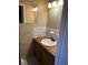 Small bathroom with wood vanity and white sink at 6050 Ledgewood Dr, Forest Park, GA 30297