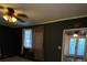 Dark-walled bedroom with access to sunroom and view of backyard at 6050 Ledgewood Dr, Forest Park, GA 30297