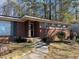 Brick ranch house with a landscaped yard at 6050 Ledgewood Dr, Forest Park, GA 30297