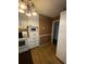 Kitchen with white cabinets and wood flooring at 6050 Ledgewood Dr, Forest Park, GA 30297