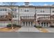 Rear view of townhome showing private decks, attached garages, and landscaping at 124 Marietta Walk Trce, Marietta, GA 30064