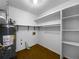 Laundry room with shelving, water heater, and wood floor at 406 Winterwood Dr, Stockbridge, GA 30281