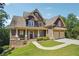 House exterior showcasing a two-story home with a stone and shingle facade, plus a three-car garage at 15 Amberly Ln, Cartersville, GA 30121