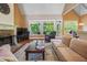 Large living area with hardwood floors, stone fireplace, and access to a screened porch at 15 Amberly Ln, Cartersville, GA 30121