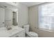 Clean bathroom, featuring a white vanity and large window at 2522 Corner Shoals Dr, Decatur, GA 30034