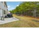 Backyard with patio, trampoline, and wooded area at 3811 River Rock Rd, Lithonia, GA 30038