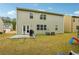 Home's backyard with patio, grill, and grassy area at 3811 River Rock Rd, Lithonia, GA 30038