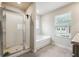 Bathroom featuring a shower, bathtub, and updated vanity at 3811 River Rock Rd, Lithonia, GA 30038