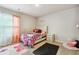 Charming bedroom with Hello Kitty bedding and window curtains at 3811 River Rock Rd, Lithonia, GA 30038