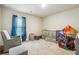 Bedroom featuring crib, armchair, and play area at 3811 River Rock Rd, Lithonia, GA 30038