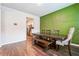 Dining room with green accent wall and wood flooring at 3811 River Rock Rd, Lithonia, GA 30038