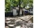 Quaint white house with blue door and large tree in front at 299 Flowers Pl, Atlanta, GA 30314