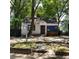 White house with blue accents, needing some repairs, located on a tree-lined street at 299 Flowers Pl, Atlanta, GA 30314