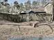 Fenced backyard with sparse grass, leaves and mature trees at 860 Flat Shoals Rd, Atlanta, GA 30349