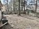 Fenced backyard with mature trees, leaves on the ground and an AC unit at 860 Flat Shoals Rd, Atlanta, GA 30349